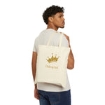 Man carrying canvas bag with words Child of God and gold glitter crown