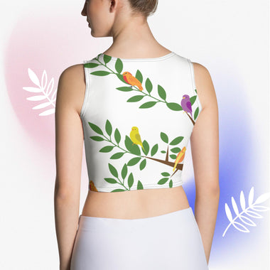 Woman wearing all-over-print cropped tank with tree branch and four colorful birds - back