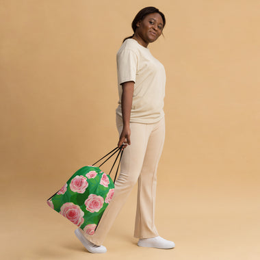 Woman carrying Lola's Doodles Pink Roses over Green Leaves Drawstring bag