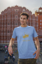 light blue t-shirt featuring gold crown words Child of God on a man