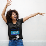 Woman with blue hope button short-sleeve t-shirt in black white finger clicking and Romans 15:13 above