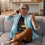 Man taking on phone wearing black Son of the Most High King t-shirt with gold crown