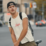 Man wearing cream t-shirt with words faith and love in white and hope in red