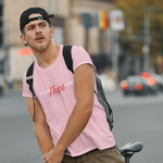 Man wearing pink t-shirt with words faith and love in white and hope in red