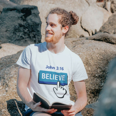 Man reading book with blue believe button short-sleeve t-shirt in white white finger clicking and John 3:16 above