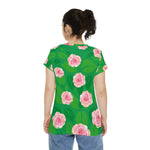 woman wearing green tunic with all-over-print pink roses back view